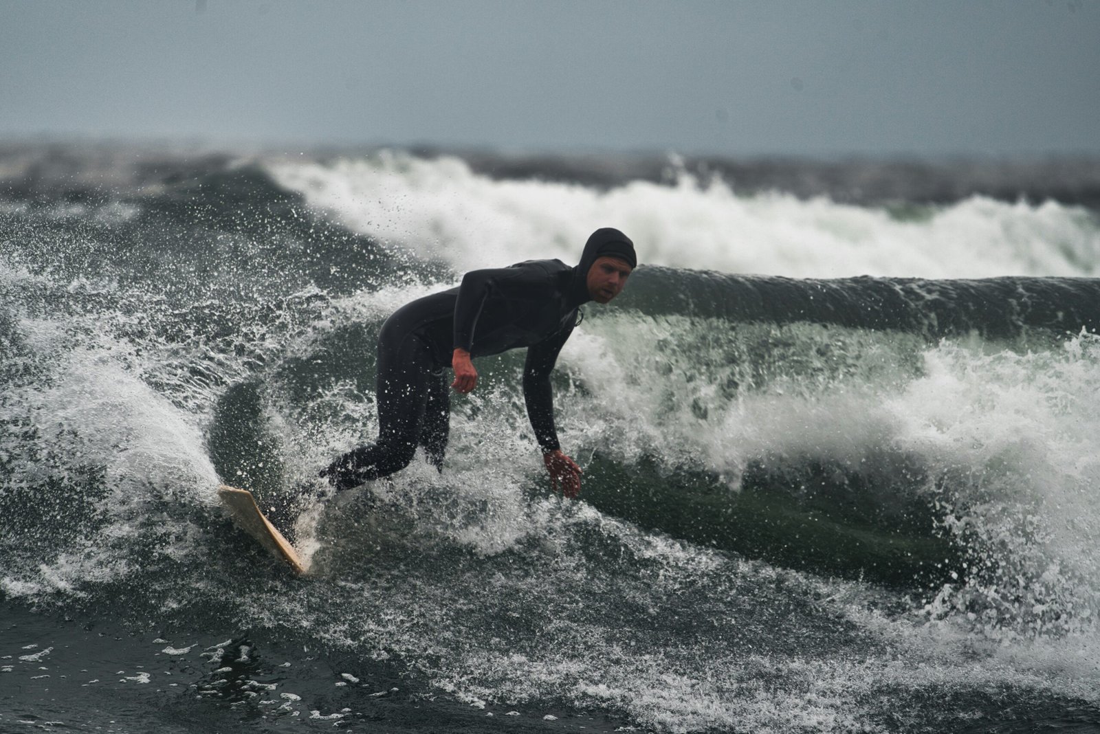 a man riding a wave on top of a surfboard